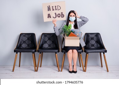 Portrait Of Attractive Desperate Fired Jobless Lady Executive Manager Sitting In Chair Holding In Hands Poster Need Job Words Belongings Wear Gauze Mask Mers Cov Isolated Pastel Gray Color Background