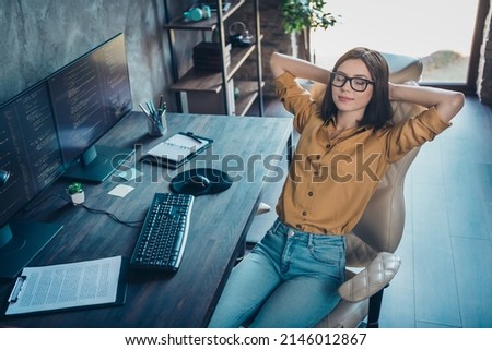 Portrait of attractive dreamy calm girl geek technician sitting resting in chair nap at workplace workstation indoors