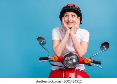 Portrait Of Attractive Dreamy Cheerful Woman Riding Motor Bike Thinking Copy Space Isolated Over Bright Blue Color Background