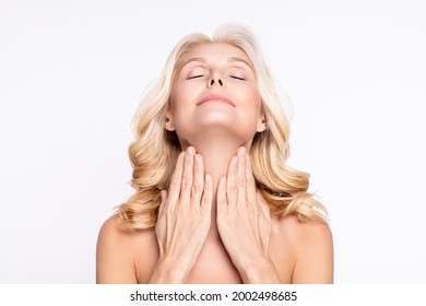 Portrait of attractive dreamy woman touching neck applying cream moisturizing wellness isolated over white color background