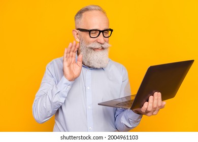 Portrait Of Attractive Elderly Cheerful Man Holding In Hand Laptop Waving Hi Calling Isolated Over Gray Pastel Color Background