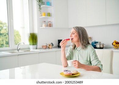 Portrait Of Attractive Elderly Dreamy Grey-haired Woman Drinking Coffee Eating Yummy Tasty Bakery At Home Light White Indoors