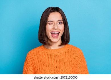 Portrait of attractive flirty cheerful girl winking good mood isolated over vibrant blue color background