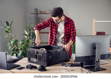 Portrait of attractive focused skilled trendy guy fixing improving motherboard processor at studio office workplace workstation indoor - Powered by Shutterstock