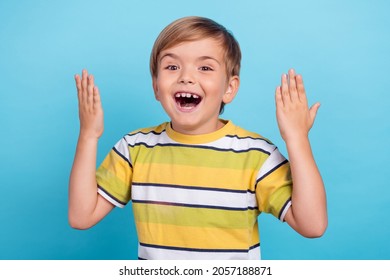 Portrait of attractive friendly amazed cheerful boy saying story isolated over bright blue color background - Shutterstock ID 2057188871