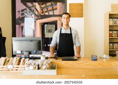 Portrait Of An Attractive Friendly Worker Standing Behind The Counter And Ready To Receive Customers At The Sustainable Grocery Store