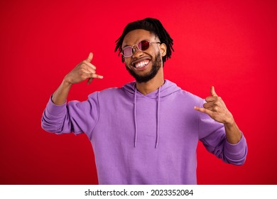 Portrait of attractive funky brunet cheerful guy showing phone sign operator isolated over bright red color background - Powered by Shutterstock