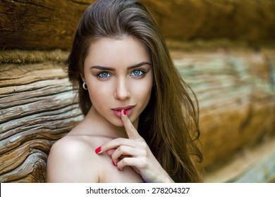 Portrait of attractive girl with finger on lips, concept of student show quiet, silence, secret gesture, young pretty brunette woman