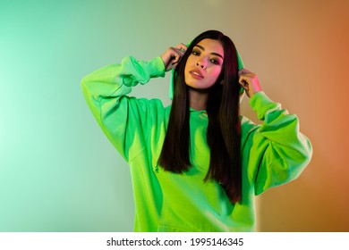 Portrait of attractive girl posing resting spending free time club isolated over multicolor vivid neon light background