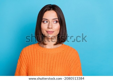Portrait of attractive girlish cheerful girl looking aside overthinking isolated over bright blue color background