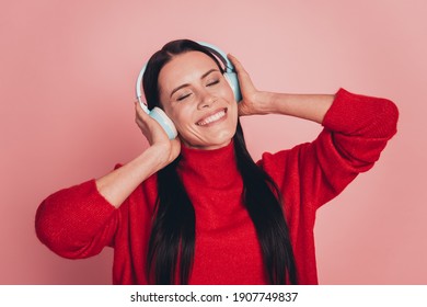 Portrait of attractive girlish girl listening hit song isolated on pink color background