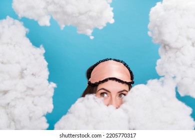Portrait of attractive girly girl waking up hiding behind fluffy clouds flying isolated over bright blue color background