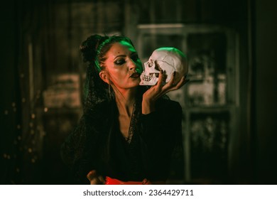 Portrait of an attractive Halloween woman holding skull. - Powered by Shutterstock