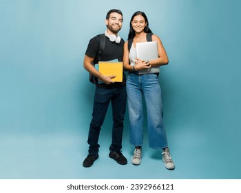 Portrait of an attractive happy college students and studying partners carrying their books and smiling ready for university - Powered by Shutterstock