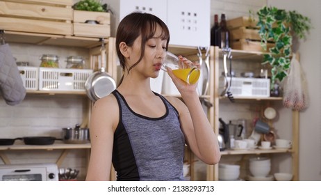 Portrait Attractive Lady Drinking Juice From Glass After Morning Exercise. Starting Day With Healthy Drink Concept. Genuine Lifestyle