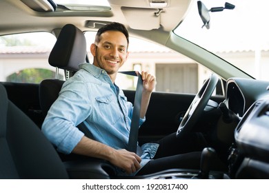 Portrait of an attractive latin man smiling before starting to work as a taxi driver of a car sharing service on a mobile app 