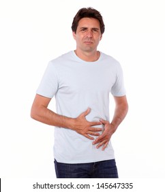 Portrait Of An Attractive Male With Pain In Stomach While Standing On Isolated Background