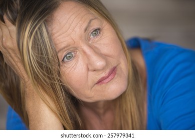 Portrait Attractive Mature Woman With Sad, Lonely, Depressed And Stressed Facial Expression, Worried, Blurred Background.