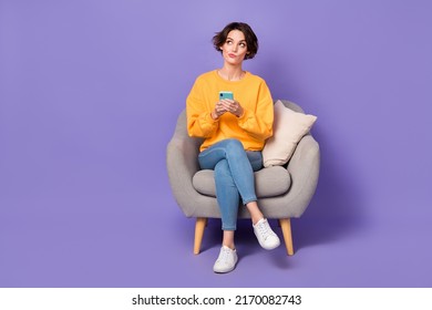 Portrait of attractive minded girl sitting using gadget chatting creating post smm isolated over violet lilac color background - Powered by Shutterstock