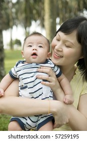 Portrait Of Attractive Mum With Her Baby