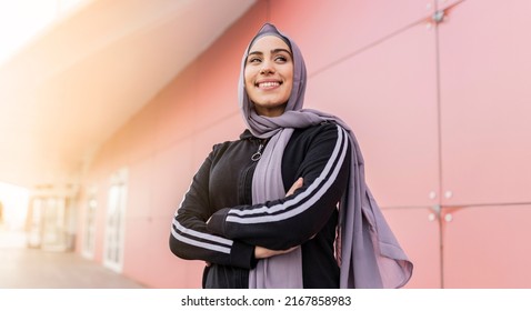 portrait of attractive muslim sporty woman with hijab outdoors - Powered by Shutterstock