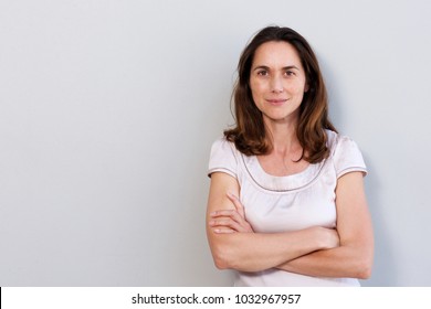 Portrait Of Attractive Older Woman Against White Wall