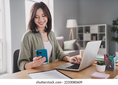 Portrait of attractive positive lady sit chair use wireless netbook telephone write typing modern office indoors - Powered by Shutterstock