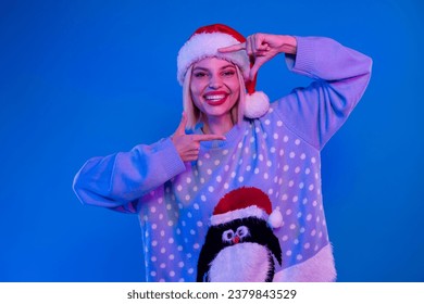 Portrait of attractive positive person toothy smile arms fingers show cadre focus gesture isolated on blue color neon background - Powered by Shutterstock