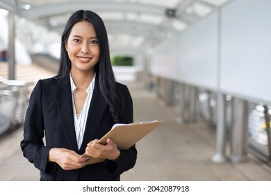 Portrait attractive professional asian business woman look at camera at outside office building. - Shutterstock ID 2042087918