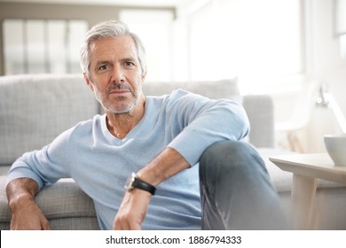 Portrait Of Attractive Senior Man With Blue Sweater Relaxing At Home