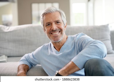 Portrait Of Attractive Senior Man With Blue Sweater Relaxing At Home