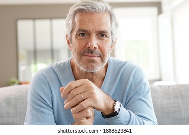 Portrait Of Attractive Senior Man With Blue Sweater Relaxing At Home