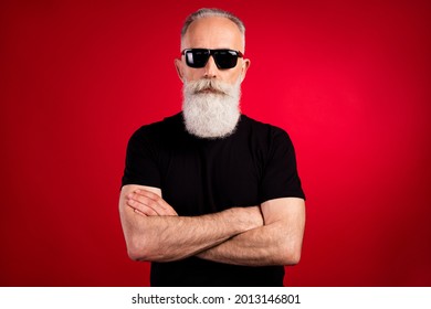Portrait attractive serious strong grey  haired man life saver folded arms isolated over bright red color background