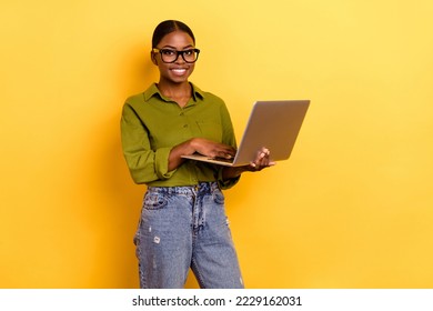 Portrait of attractive skilled cheerful girl copywriter using laptop isolated over bright yellow color background - Shutterstock ID 2229162031