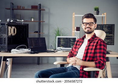 Portrait Of Attractive Smart Cheerful Guy Hacker Programming Code Security Data Remote Assistance At Work Place Station Indoors