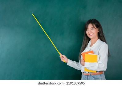 Portrait Attractive Of Smiling Asian Teacher Woman Teaching Student In Online Classroom, Female Teacher Present Empty On Blackboard, High School And Back To School Concept.