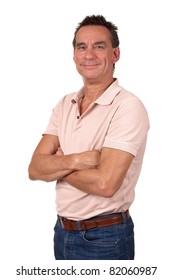 Portrait Of Attractive Smiling Middle Age Man In Pink Polo Shirt And Blue Jeans