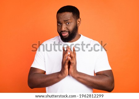 Portrait of attractive sporty funny sly guy waiting planning joke isolated over bright orange color background