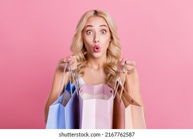 Portrait Of Attractive Stunned Wavy-haired Girl Buying Clothes Gifts Pout Lips Isolated Over Pink Pastel Color Background