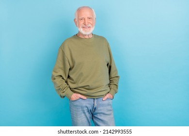 Portrait of attractive successful cheerful grey-haired man holding hands in pockets isolated over bright blue color background - Shutterstock ID 2142993555