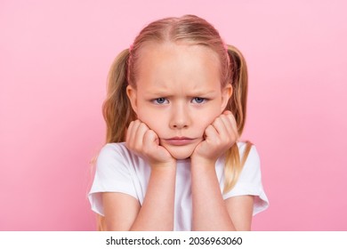 Portrait of attractive sullen mad blond girl bad mood fail failure isolated over pink pastel color background