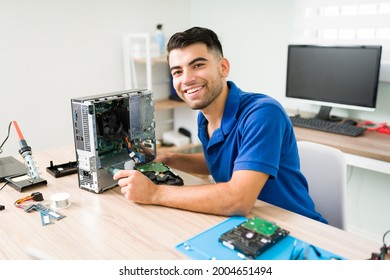 Portrait of an attractive technician feeling happy at the repair shop while fixing a damaged computer hardware 