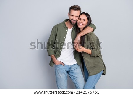 Portrait of attractive tender gentle cheerful couple life partners cuddling romance isolated over grey pastel color background