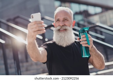 Portrait Of Attractive Virile Retired Cheerful Grey-haired Man Taking Making Selfie Doing Physical Culture Work Out Outside Outdoors