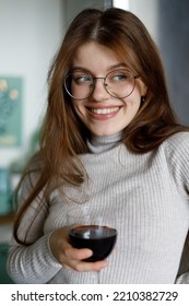 Portrait Of An Attractive Woman With A Glass Of Red Wine In Her Hand. Enjoy Alcohol At Your Leisure.