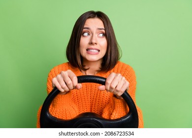 Portrait of attractive worried frustrated girl holding steering wheel rental driving learning isolated over bright green color background