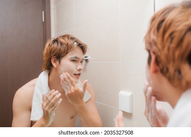 Portrait Of Attractive Young Asian Male Wash His Face In Bathroom