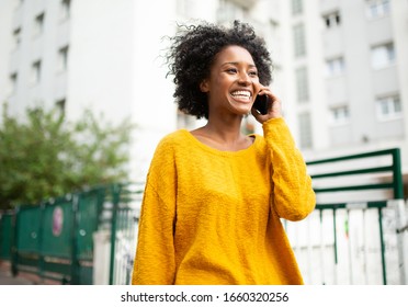 Portrait Attractive Young Black Woman Walking In City Talking With Cellphone