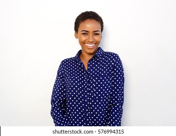 Portrait of attractive young black woman smiling against isolated white background