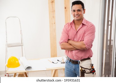 Portrait Of An Attractive Young Contractor Working At A House And Smiling